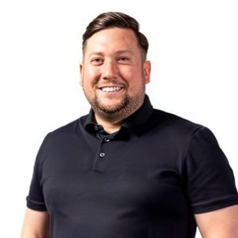 Smiling man with dark hair wearing a black polo shirt against a white background, professional headshot