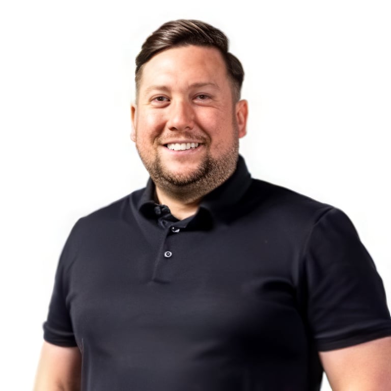 Smiling man with dark hair wearing a black polo shirt against a white background, professional headshot